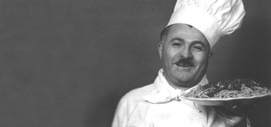 Photo of Chef Boyardee holding a plate of spaghetti